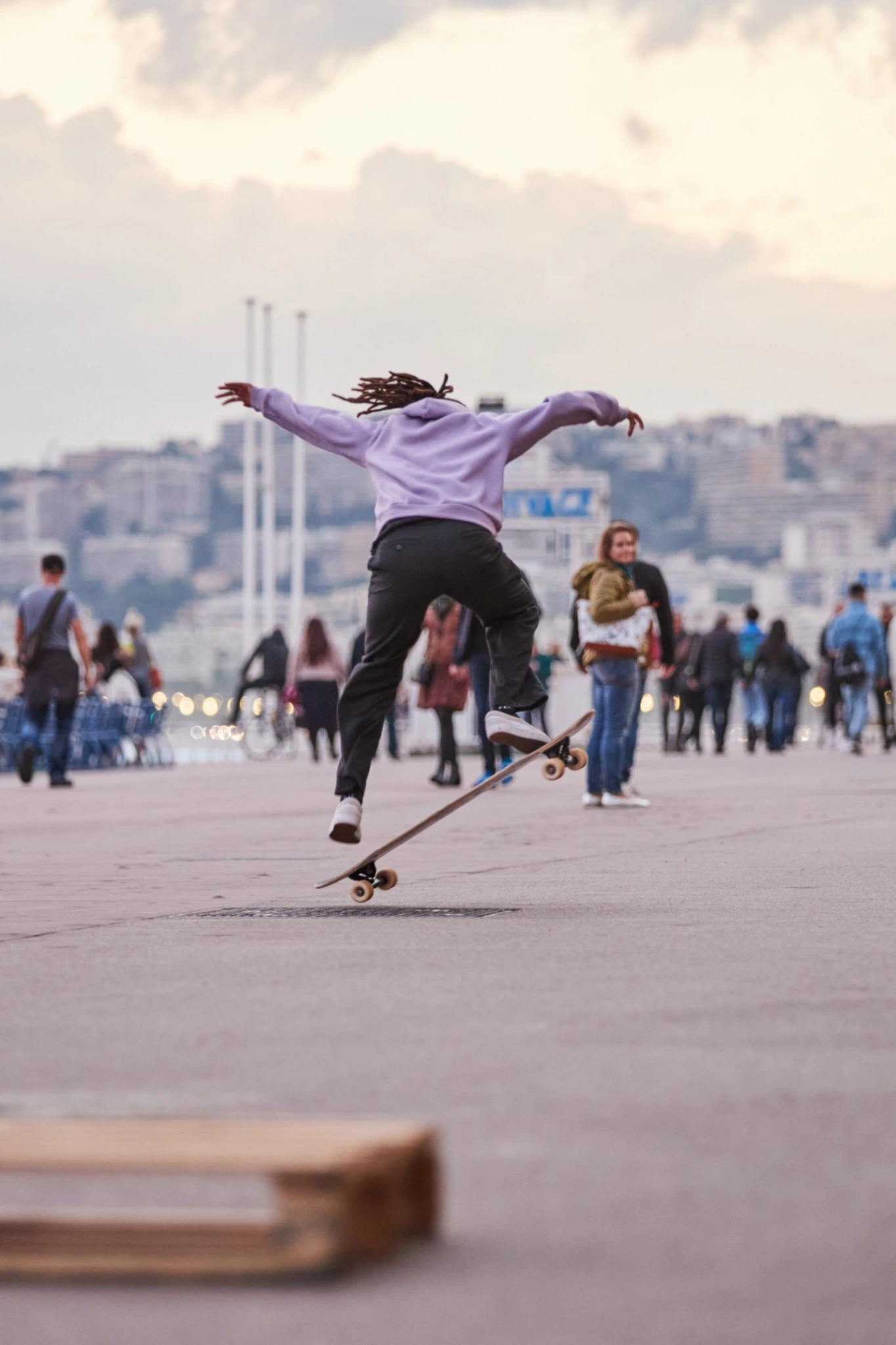 Skateboarder jumping above the promenade in evening light — Urban / Action series — photograph by Michaël Gramm